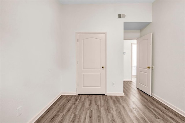 unfurnished bedroom featuring hardwood / wood-style flooring