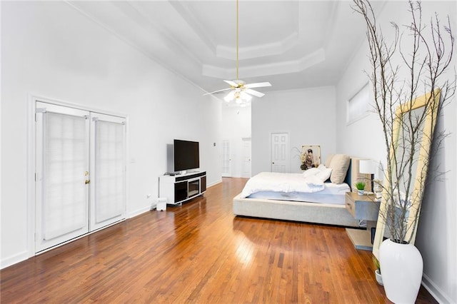 385 Windermere Cir, Newnan, GA 30265 - bedroom with a raised ceiling, wood finished floors, a ceiling fan, and crown molding