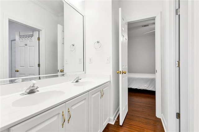 385 Windermere Cir, Newnan, GA 30265 - ensuite bathroom with ornamental molding, double vanity, and wood finished floors
