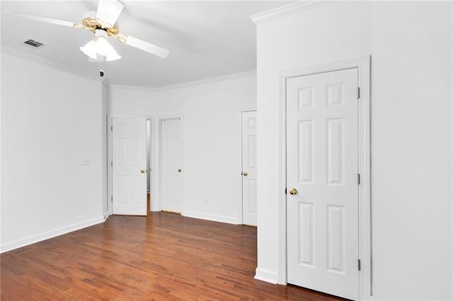 385 Windermere Cir, Newnan, GA 30265 - unfurnished bedroom with ornamental molding, dark wood-type flooring, baseboards, and ceiling fan