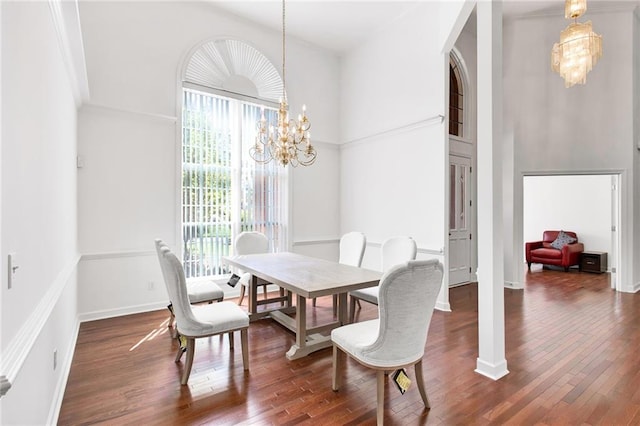 385 Windermere Cir, Newnan, GA 30265 - dining area with a chandelier, wood finished floors, a towering ceiling, and baseboards