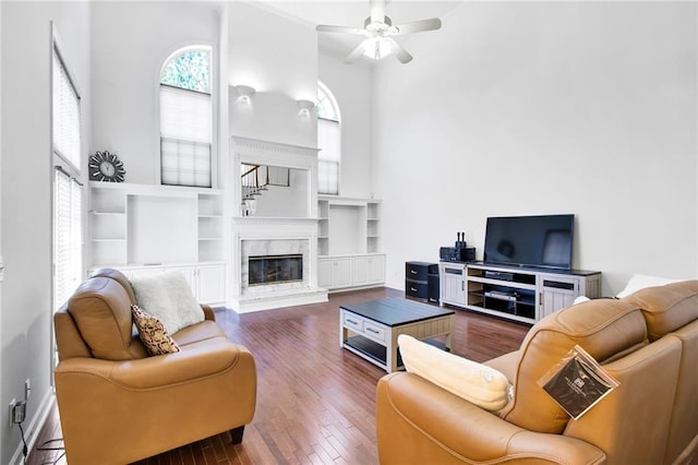 385 Windermere Cir, Newnan, GA 30265 - living area with a high ceiling, ceiling fan, wood finished floors, and a fireplace