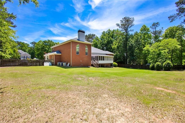 385 Windermere Cir, Newnan, GA 30265 - view of home's exterior with a chimney and a sunroom