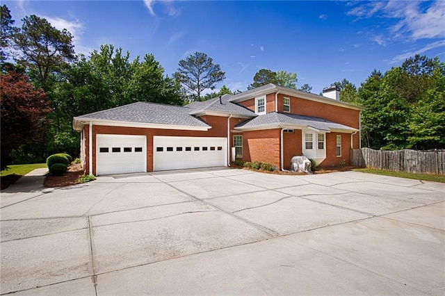 385 Windermere Cir, Newnan, GA 30265 - view of front facade featuring driveway, a garage, a chimney, and brick siding