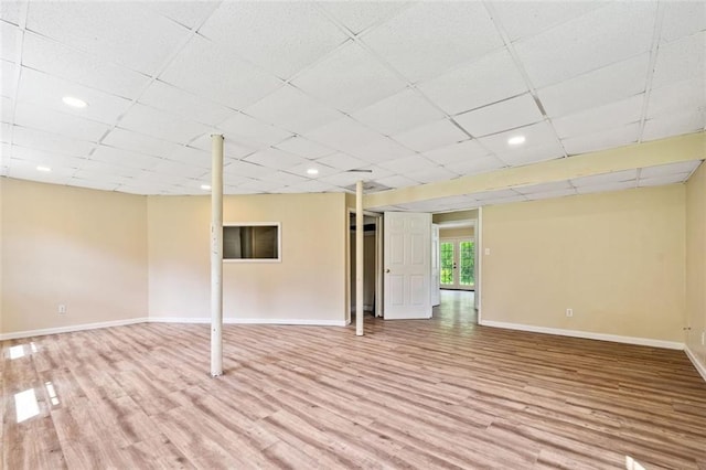 below grade area featuring baseboards, wood finished floors, and recessed lighting