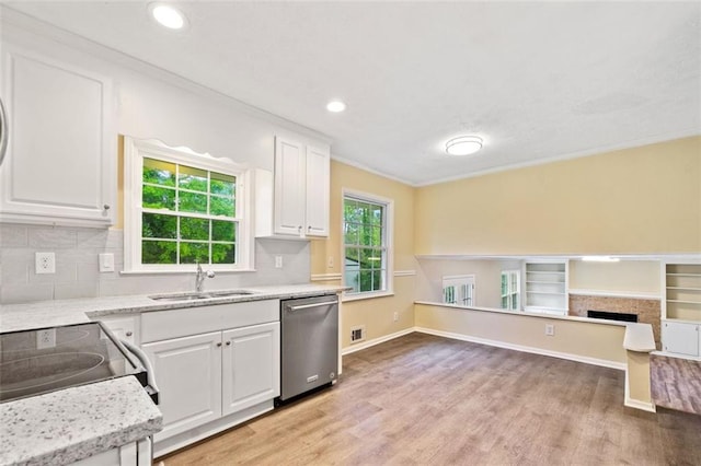 kitchen featuring a sink, light wood-style floors, white cabinetry, crown molding, and dishwasher