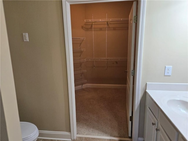 2110 Retreat Haven Ln, Dacula, GA 30019 - bathroom with a spacious closet, vanity, and toilet
