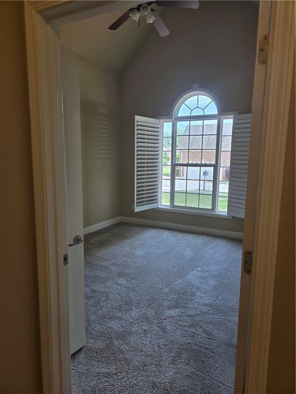 2110 Retreat Haven Ln, Dacula, GA 30019 - carpeted empty room with ceiling fan, high vaulted ceiling, and baseboards