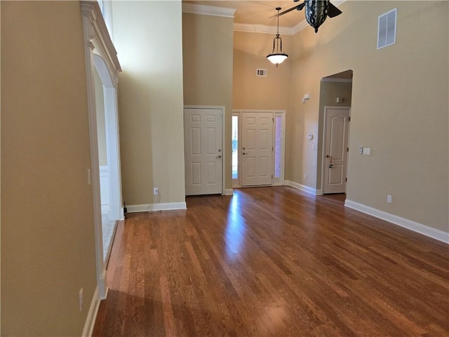 2110 Retreat Haven Ln, Dacula, GA 30019 - foyer featuring a ceiling fan, a high ceiling, ornamental molding, wood finished floors, and baseboards