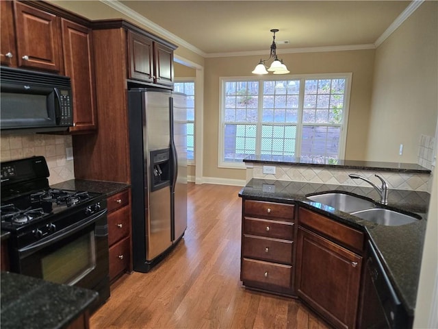 2110 Retreat Haven Ln, Dacula, GA 30019 - kitchen with black appliances, a sink, light wood finished floors, decorative backsplash, and ornamental molding