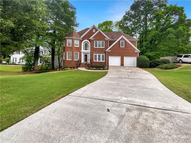 colonial house with an attached garage, concrete driveway, brick siding, and a front yard