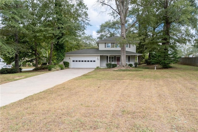 view of front of home with a front lawn, covered porch, and a garage