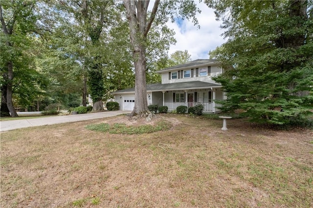 view of front facade featuring covered porch, a garage, and a front lawn