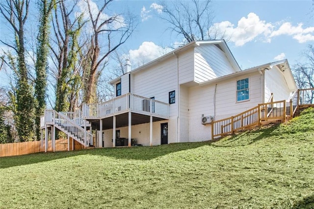 back of house featuring a lawn, central AC unit, and a deck