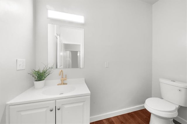 bathroom featuring hardwood / wood-style floors, toilet, and vanity