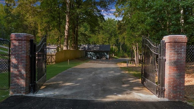 view of gate featuring an outdoor structure