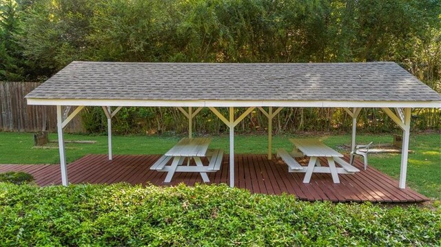 exterior space featuring a gazebo, a deck, and a lawn