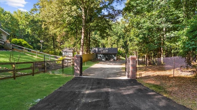 view of gate with a yard