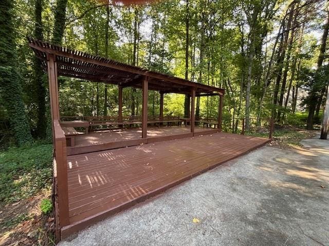 view of community featuring a pergola and a wooden deck