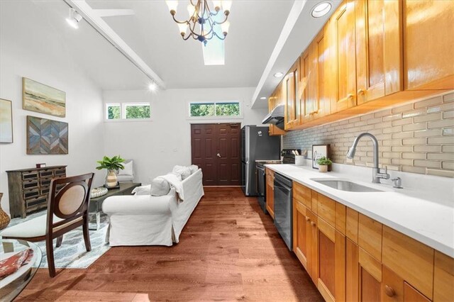 kitchen featuring light hardwood / wood-style flooring, dishwashing machine, track lighting, sink, and a notable chandelier