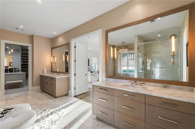 bathroom with visible vents, two vanities, a stall shower, marble finish floor, and a sink