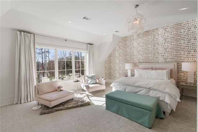 carpeted bedroom with visible vents, a notable chandelier, brick wall, and an accent wall