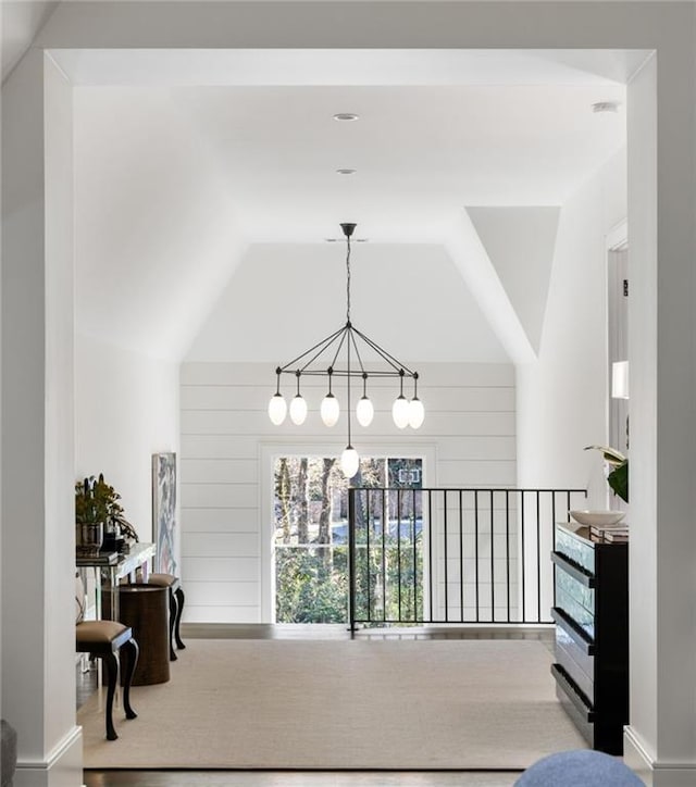 corridor featuring wooden walls and lofted ceiling