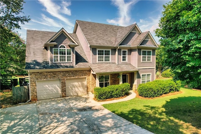 view of front of property featuring a front lawn and a garage