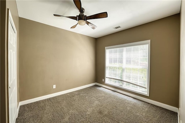 empty room featuring carpet and ceiling fan