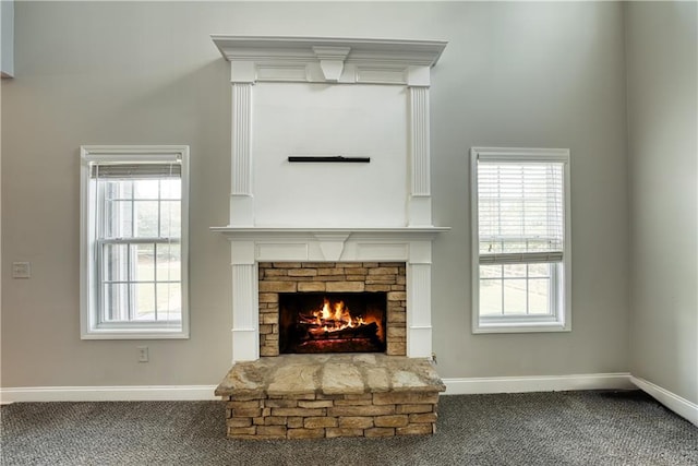 interior details featuring a fireplace and carpet floors