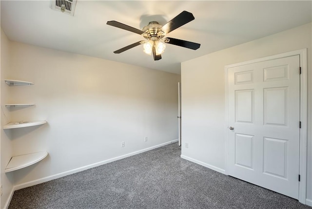 unfurnished bedroom with ceiling fan and dark carpet