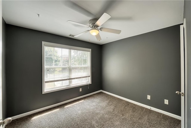 empty room with carpet and ceiling fan