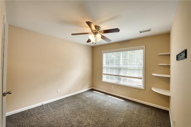 carpeted empty room featuring ceiling fan