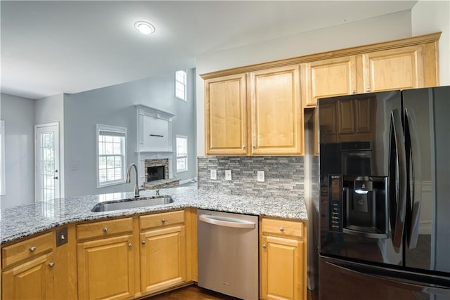 kitchen with dishwasher, sink, decorative backsplash, black fridge with ice dispenser, and kitchen peninsula