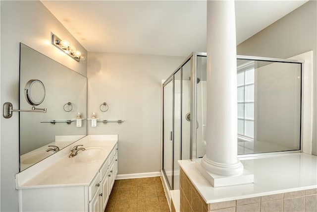 bathroom with tile patterned floors, vanity, ornate columns, and walk in shower