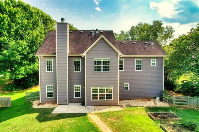 back of property with a yard and a patio area