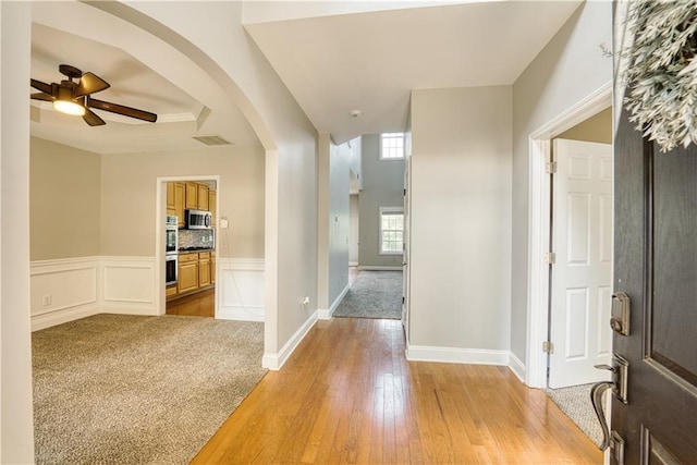 entryway with ceiling fan and light hardwood / wood-style floors