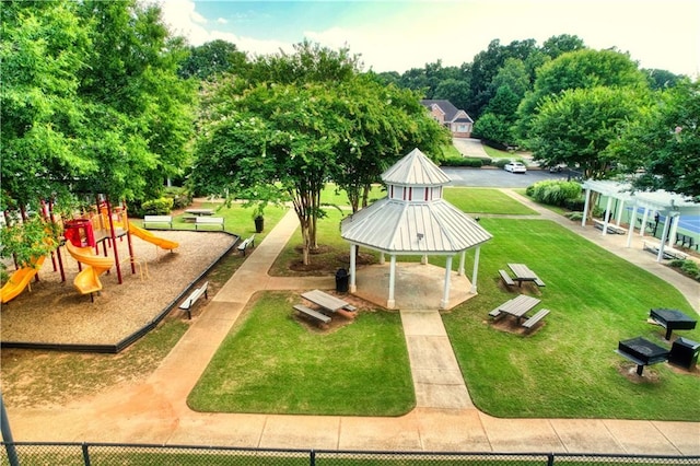 view of community with a gazebo, a playground, and a lawn