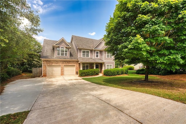 view of front of property with a front lawn and a garage