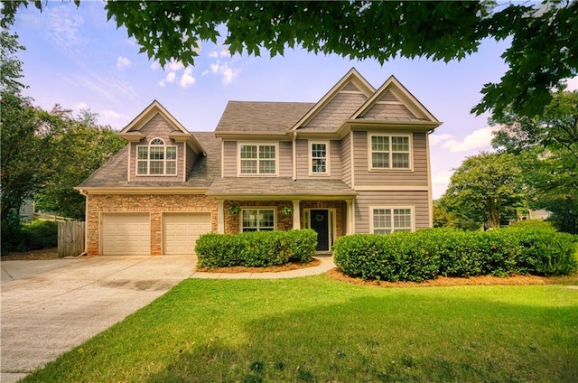 view of front of house with a garage and a front lawn