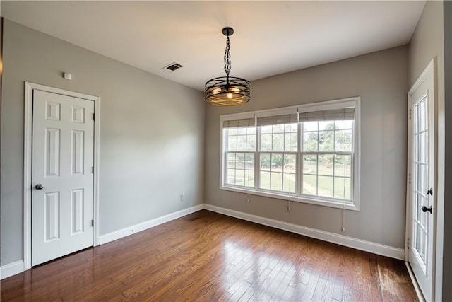 unfurnished room with dark hardwood / wood-style floors and a notable chandelier