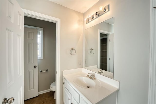 bathroom with tile patterned floors, vanity, and toilet