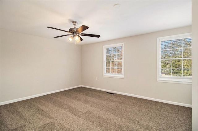 carpeted spare room featuring ceiling fan