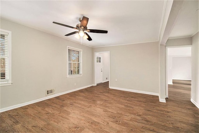 spare room featuring ornamental molding, ceiling fan, and dark hardwood / wood-style floors