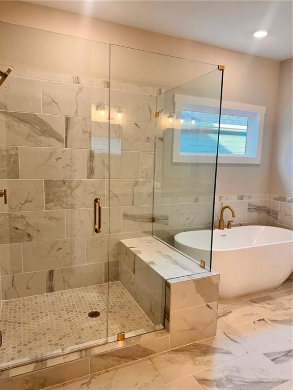 101 Red Oak Ln, Carrollton, GA 30116 - bathroom with a freestanding bath, a stall shower, and marble finish flooring