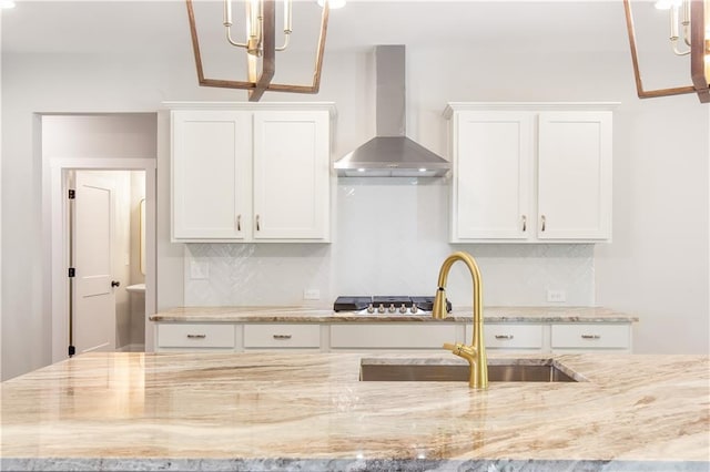 101 Red Oak Ln, Carrollton, GA 30116 - kitchen featuring wall chimney range hood, a sink, white cabinets, and tasteful backsplash