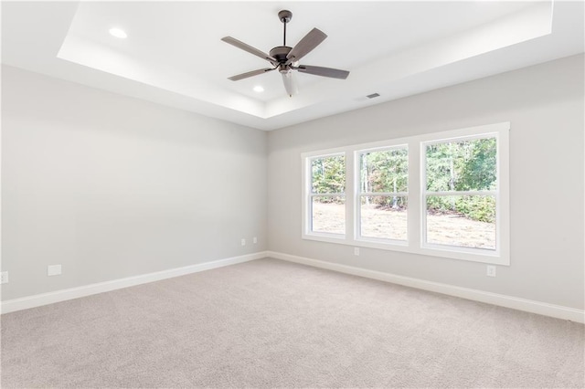 101 Red Oak Ln, Carrollton, GA 30116 - spare room featuring a raised ceiling, recessed lighting, baseboards, light carpet, and a ceiling fan