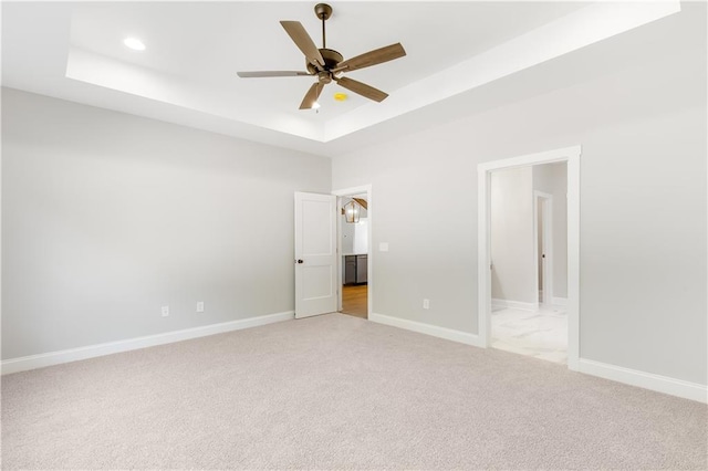 101 Red Oak Ln, Carrollton, GA 30116 - unfurnished bedroom with a raised ceiling, light colored carpet, baseboards, recessed lighting, and a ceiling fan