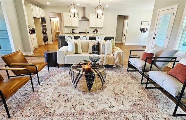 101 Red Oak Ln, Carrollton, GA 30116 - living room with baseboards, recessed lighting, light wood-style flooring, and a chandelier