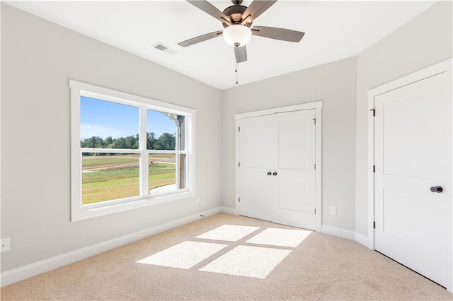 101 Red Oak Ln, Carrollton, GA 30116 - unfurnished bedroom featuring light carpet, baseboards, a closet, and ceiling fan